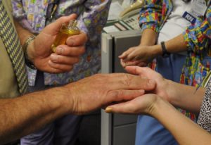 A blessing of hands — Chaplain blesses caregivers